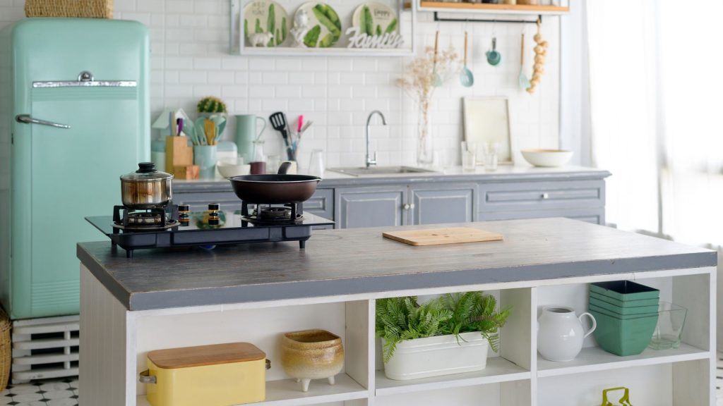 A bright Blacktown kitchen with a grey benchtop island, open display shelving and white subway tiles, planned and installed by 10X Joinery.