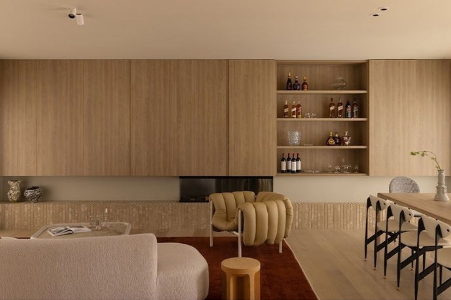 Custom joinery in a Sydney living and dining room, with full-wall timber cabinetry and open bar shelving, designed and built by 10X Joinery.