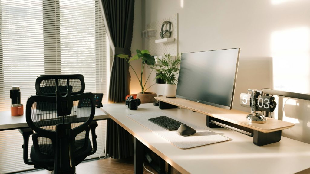 A custom home office desk with a timber monitor riser and ergonomic chair in a bright Sydney home, made by 10X Joinery.