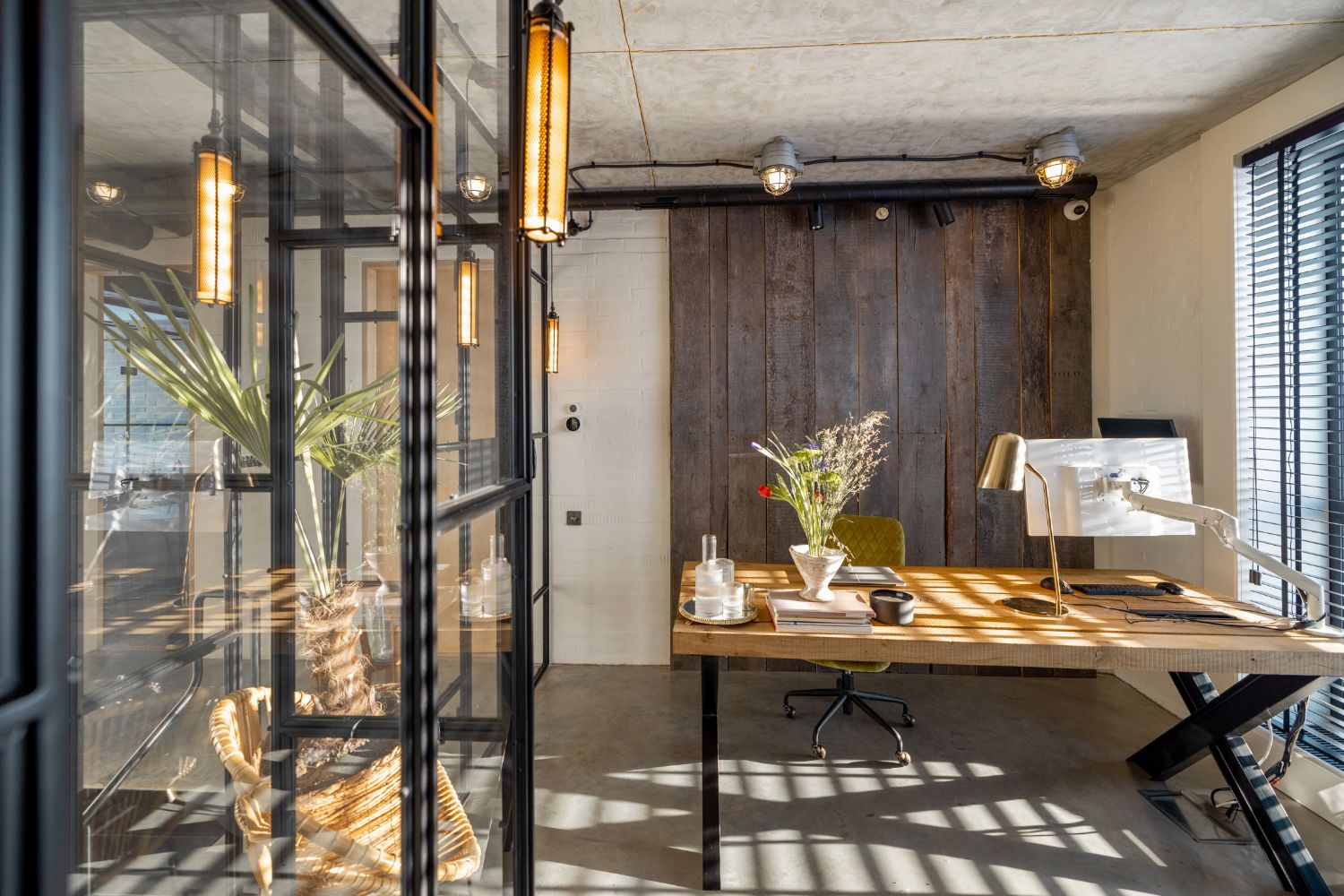 Home office joinery in Sydney with a timber desk, recycled timber feature wall and black steel-framed glass partition, designed and built by 10X Joinery.