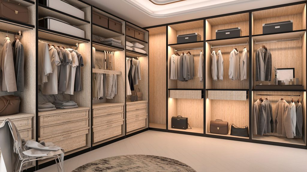 A luxury walk-in robe in Sydney with dark-framed timber shelving, LED-lit hanging sections and built-in drawers, delivered by 10X Joinery.