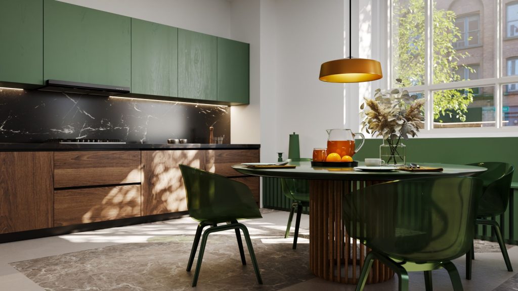 An Auburn kitchen with green overhead cabinets, timber lower cabinetry and a black marble-look splashback beside a round dining table, renovated by 10X Joinery.