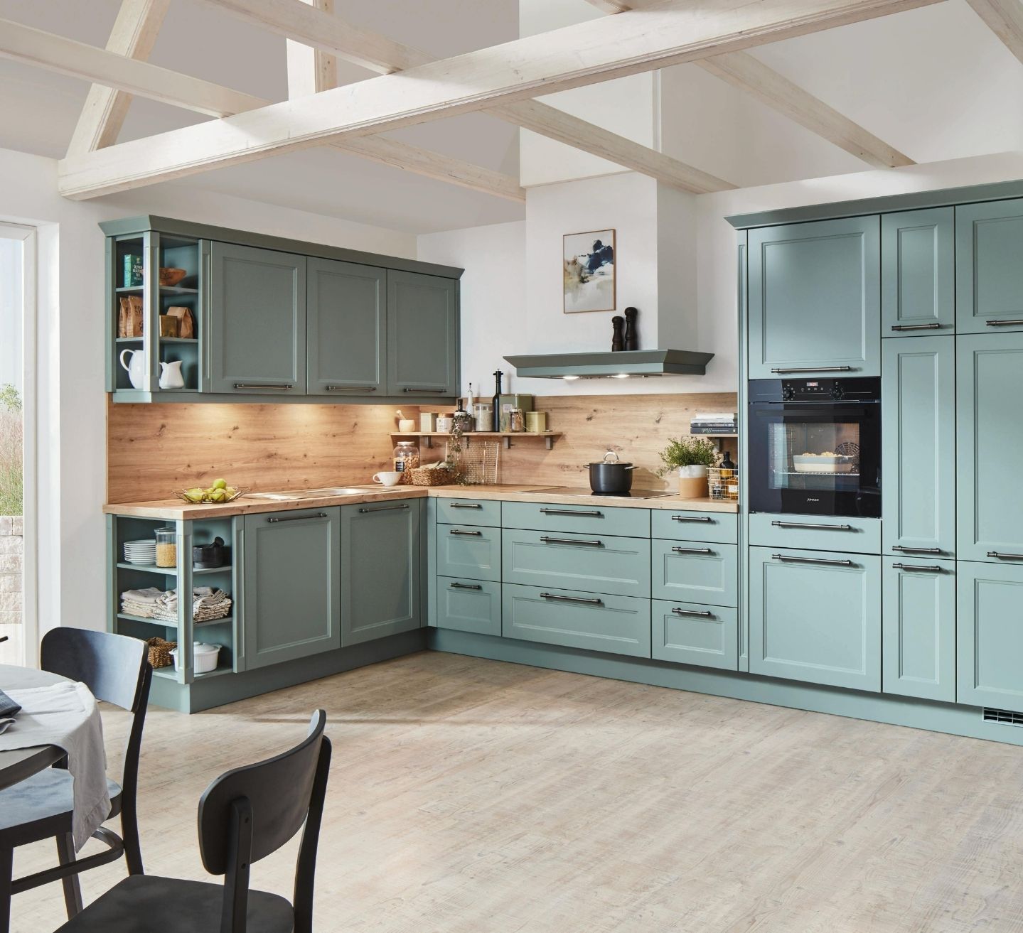 Kitchen joinery design in Baulkham Hills with sage green shaker cabinets, a timber benchtop and splashback under a vaulted beamed ceiling by 10X Joinery.