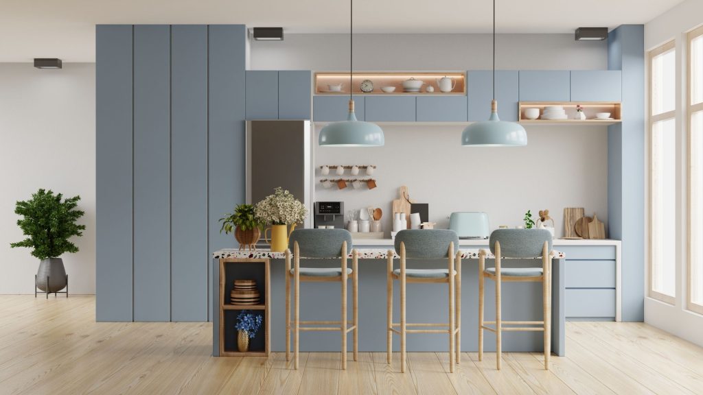 A pale blue kitchen with full-height panelled cabinetry, a terrazzo-top island and timber stools in a Baulkham Hills home by 10X Joinery.