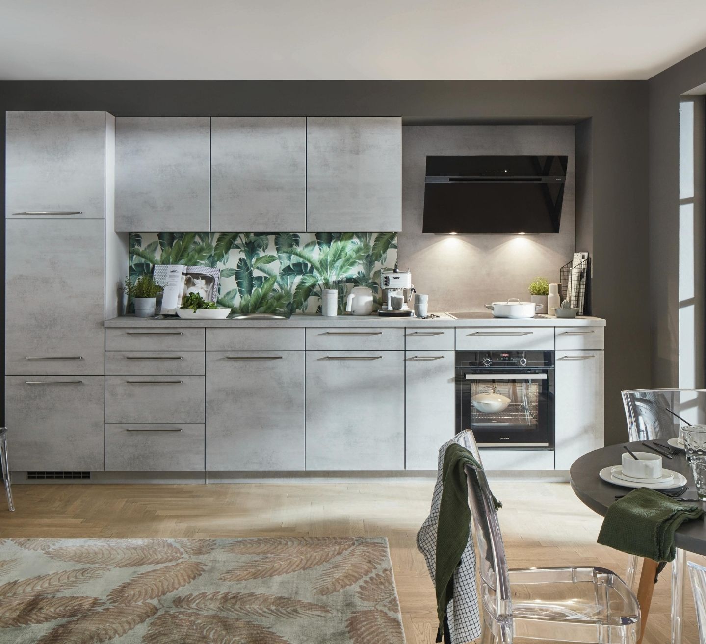 Kitchen joinery design made in Castle Hill, with concrete-look grey cabinetry, a botanical print splashback and angled black rangehood by 10X Joinery.