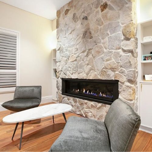 Stone feature fireplace with built-in shelving installed by 10X Joinery in a new Sydney home