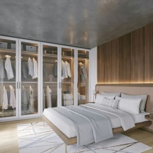 Floor-to-ceiling built-in wardrobes with glass doors in a Sydney bedroom, fitted wall to wall with no gaps by 10X Joinery.