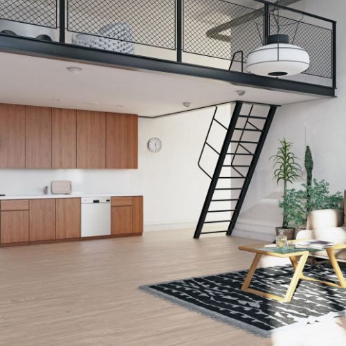 A timber-look kitchen along one wall of an open-plan Auburn townhouse, with storage planned within the existing footprint by 10X Joinery.
