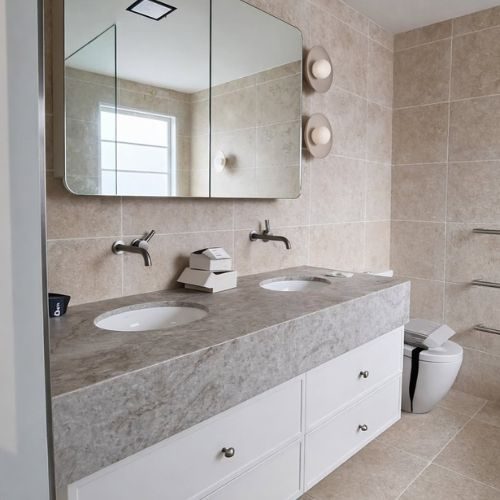 Bathroom renovation with stone-top floating vanity, double basins and mirrored cabinet