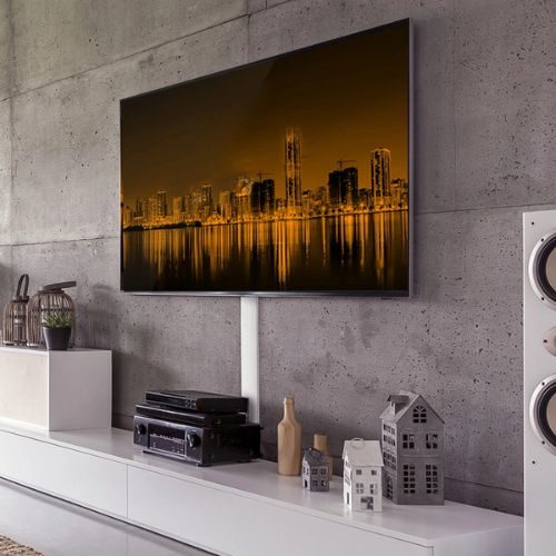 A wall-mounted TV above a floating white media console with hidden cable channels, installed in a Sydney home by 10X Joinery.