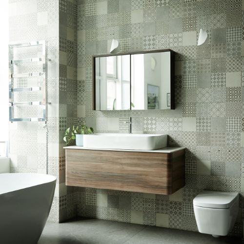 A wall hung timber vanity with a white basin and mirror cabinet above, set against patterned grey tiles, made by 10X Joinery, Sydney.