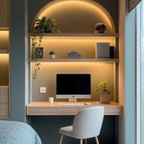 A built-in timber desk and shelving in a lit arched niche, creating a compact home office by 10X Joinery.