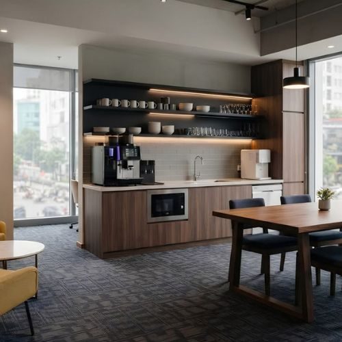 A staff breakout kitchenette in a Sydney office with timber cabinetry, open shelving and a dining table, fitted out by 10X Joinery.