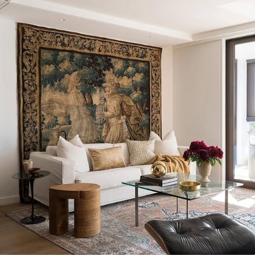Styled living room with custom joinery, sofa and large wall tapestry