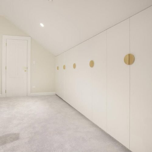 Built-in white wardrobes with brass handles fitted by 10X Joinery in a Sydney new build
