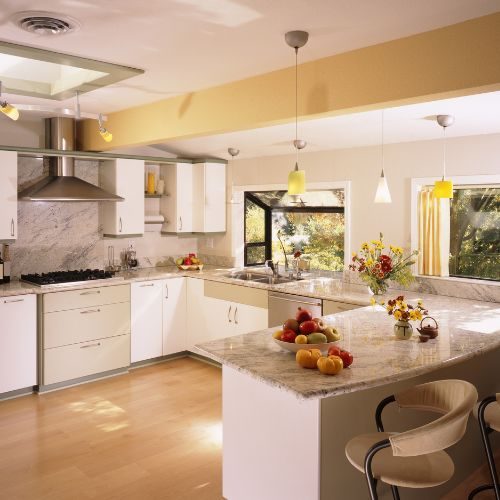 A complete kitchen renovation in Blacktown with white cabinetry, a granite peninsula and pendant lighting by 10X Joinery.
