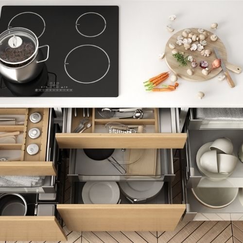 Deep pull-out kitchen drawers for pots, pans and plates under the cooktop, custom storage for a Baulkham Hills home by 10X Joinery.